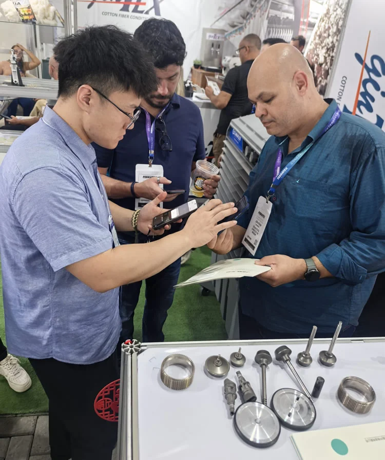 JSM team presenting rotor spinning spare parts to visitors at FEBRATEX 2026, Blumenau