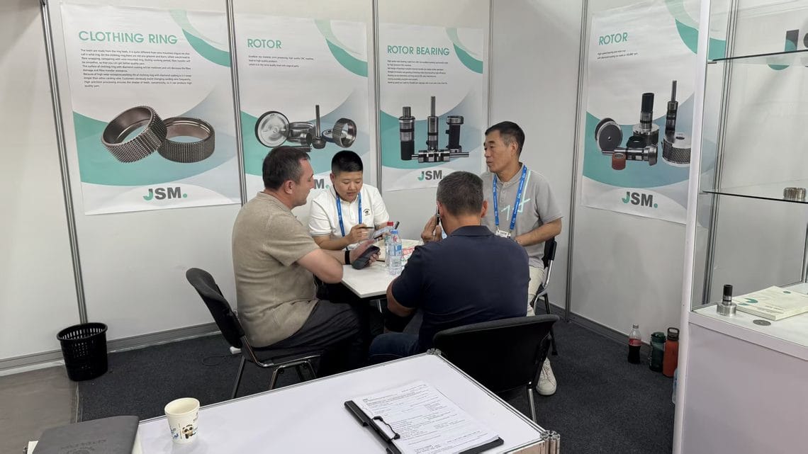 JSM booth team and visitors reviewing rotor, clothing ring and rotor bearing specifications during CAITME 2026 in Tashkent